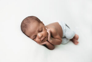 Newborn Photography in Martinez, Ga &amp; Augusta, Ga - Baby boy newborn posed in gray pants on white backdrop